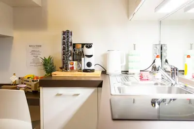 a kitchen with a sink and a counter at Cute Tiny Flat in Ljubljana