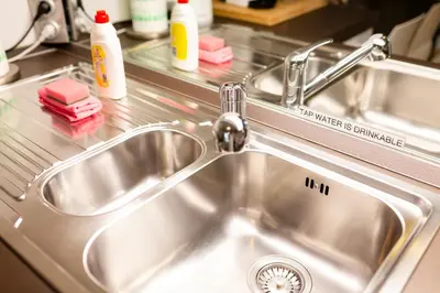 a stainless steel kitchen sink with a faucet at Cute Tiny Flat in Ljubljana