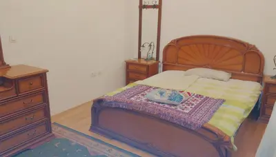 a bedroom with a wooden bed with a book on it at Bright&Spaceus Apartment with View in Nova Gorica