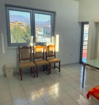 a dining room with a table and chairs and windows at Bright&Spaceus Apartment with View in Nova Gorica