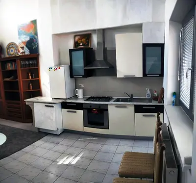 a kitchen with white cabinets and a stove top oven at Bright&Spaceus Apartment with View in Nova Gorica