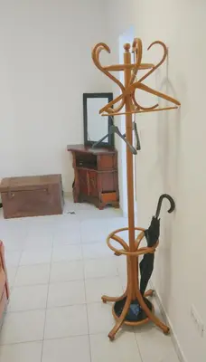 a umbrella stand in a room with a mirror at Bright&Spaceus Apartment with View in Nova Gorica