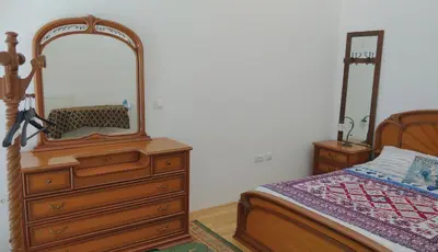 a bedroom with a dresser and a mirror next to a bed at Bright&Spaceus Apartment with View in Nova Gorica