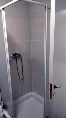 a shower with a glass door in a bathroom at Bright&Spaceus Apartment with View in Nova Gorica