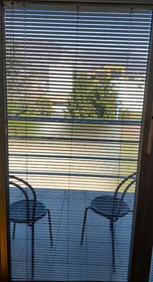 two chairs and a table in front of a window at Bright&Spaceus Apartment with View in Nova Gorica