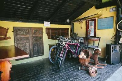 a couple of bikes parked next to a building with a dog at Guest House Kraljev Hrib in Kamniška Bistrica