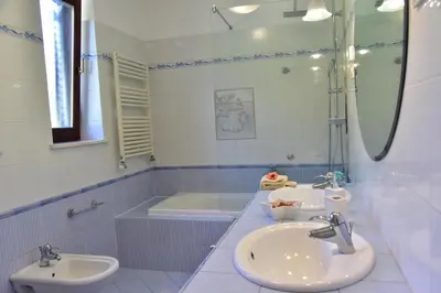 a bathroom with two sinks and a tub at Apartment JANG in Tolmin