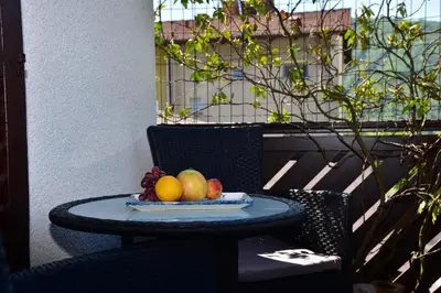 a plate of fruit on a table on a patio at Apartment JANG in Tolmin