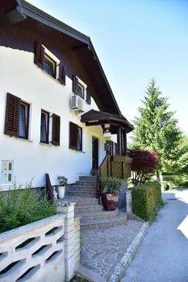 a house with stairs leading to the front entrance at Apartment JANG in Tolmin