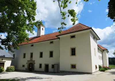 a large white building with a tower at Grad Tuštanj in Moravče