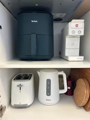 a shelf with a toaster and printers on it at Apartment Gallus in Bled