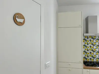a room with a white door and a cabinet of wine bottles at Apartment Gallus in Bled
