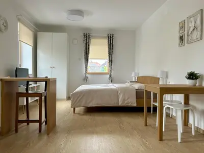 a bedroom with a bed and two tables and a desk at Apartment Gallus in Bled