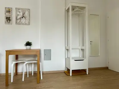 a room with a desk and a table and a mirror at Apartment Gallus in Bled