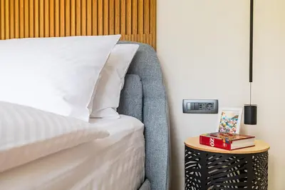 a bedroom with a bed and a side table at Vila Nina Bohinj in Bohinj