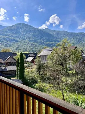 a balcony with a view of a town and mountains at Vila Nina Bohinj in Bohinj