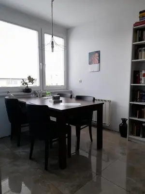 a dining room with a table and some chairs at Room for women or couples in Ljubljana