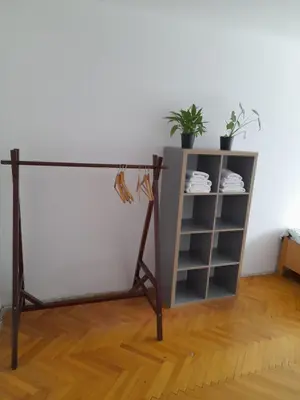 a stand with a table and a shelf at Room for women or couples in Ljubljana