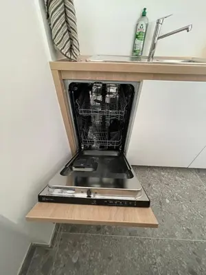 a broken laptop sitting on a shelf in a kitchen at Apartma Adrian in Kranjska Gora
