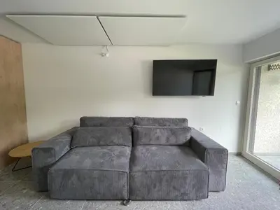 a living room with a couch and a flat screen tv at Apartma Adrian in Kranjska Gora