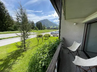 a balcony with two chairs and a view of a street at Apartma Adrian in Kranjska Gora