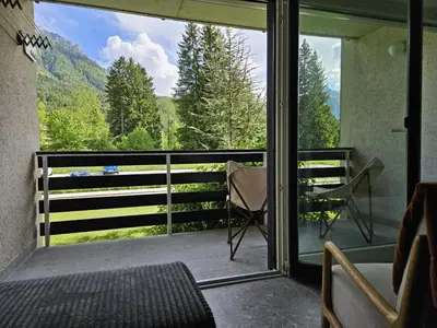 a room with a balcony with a view of the mountains at Apartma Adrian in Kranjska Gora