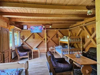 a log cabin living room with a wooden ceiling at Apartments Anž'k in Bled