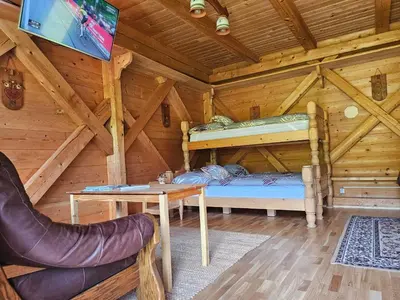 a bedroom with a bunk bed in a log cabin at Apartments Anž'k in Bled