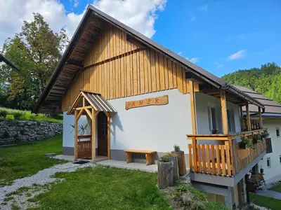 a small building with a bench in front of it at Apartments Anž'k in Bled