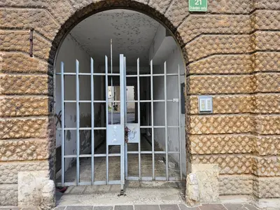an entrance to a building with a metal gate at Elegant Teo Apartment TourAs in Ljubljana Old Town in Ljubljana