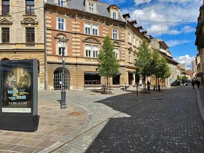 a city street with a large brick building at Elegant Teo Apartment TourAs in Ljubljana Old Town in Ljubljana