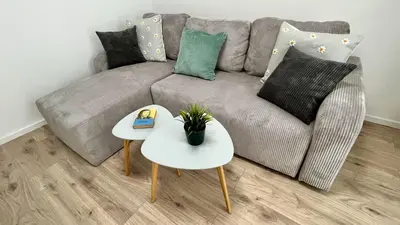 a living room with a couch and a table at Mali Raj in Mengeš