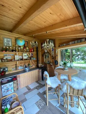 a kitchen with a table and chairs in a room at Mali Raj in Mengeš