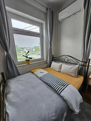 a small bedroom with a bed with a window at Soba 4 v Pekrski vili in Limbuš