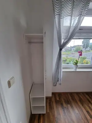 a room with a window with a curtain at Soba 4 v Pekrski vili in Limbuš
