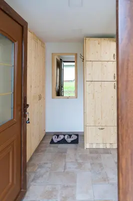 a room with a door and a pair of shoes at Studio Barbara in Bohinj