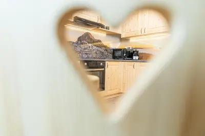 a view of a kitchen through a hole at Studio Barbara in Bohinj