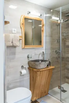 a bathroom with a sink and a toilet and a mirror at Studio Barbara in Bohinj