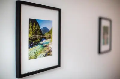 a picture frame on a wall with two pictures at Apartma 21 - Ajda in Bovec