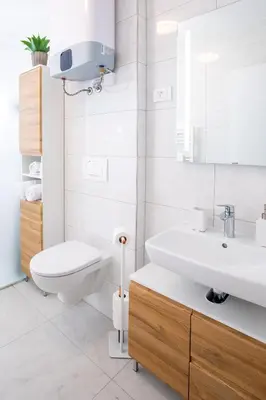a white bathroom with a toilet and a sink at Apartma 21 - Ajda in Bovec