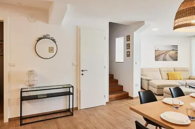 a living room with a table and a couch at VIPAVA river house in Vipava