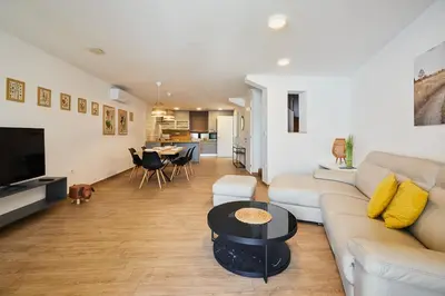 a living room with a couch and a table at VIPAVA river house in Vipava