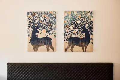 two pieces of art hanging on a wall at VIPAVA river house in Vipava