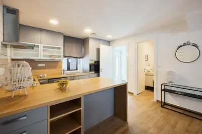 a kitchen with a large wooden counter top at VIPAVA river house in Vipava