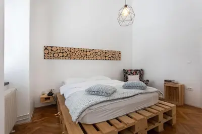 a bedroom with a bed on a wooden platform at Spacious Apartment in Historic Centre & FREE Parking in Ljubljana