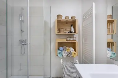 a bathroom with a shower and a sink and a glass shower at Spacious Apartment in Historic Centre & FREE Parking in Ljubljana