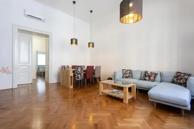 a living room with a couch and a table at Spacious Apartment in Historic Centre & FREE Parking in Ljubljana
