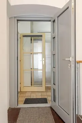 an empty room with a door and a room with a floor at Artistic Studio Quiet Crusader Street Apartment in Ljubljana