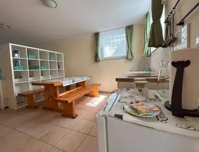 a kitchen with a table and a bench on a counter at SOS Apartments in Radovljica