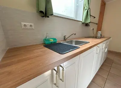 a kitchen counter top with a sink and a sink at SOS Apartments in Radovljica